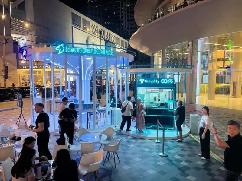 cofeplus robot coffee kiosk at outdoor plaza at night